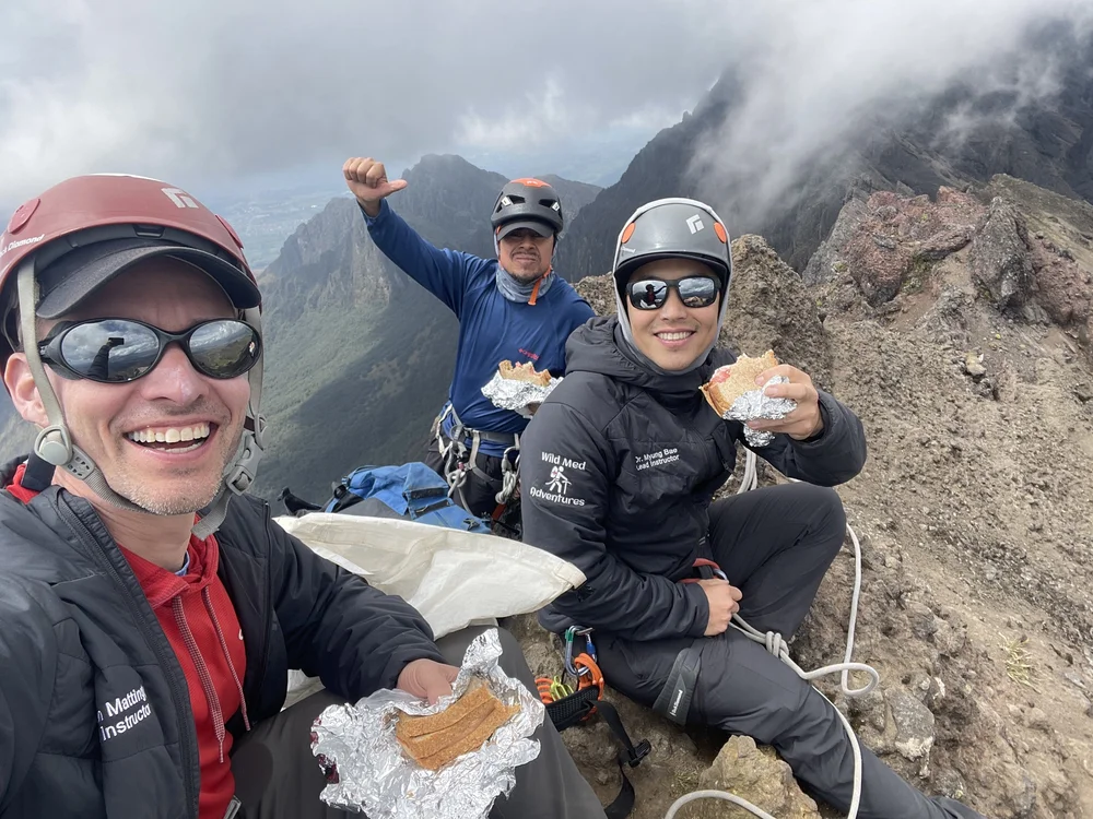 Wild Med travelers smiling together during a mountain break